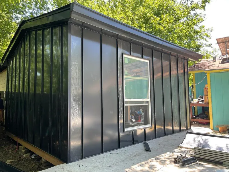 Black standing seam metal wall panels for Roof Inspection in Bartlesville