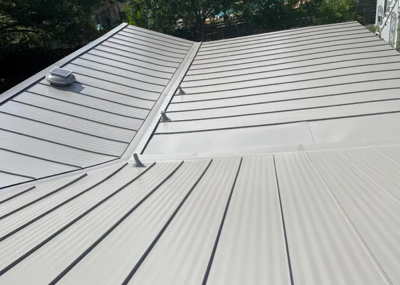 Solar attic fan installed on a metal roof for Roof Ventilation in Bartlesville